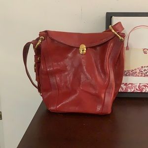 A dark red shoulder bag.